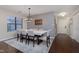 Dining room featuring a modern light fixture, seating for eight, and hardwood floors at 8198 Wade Hill Ct, Indianapolis, IN 46256
