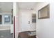 Bright entryway with a white front door, hardwood floors, and a decorative mirror at 8198 Wade Hill Ct, Indianapolis, IN 46256