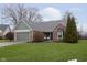 Charming single-story brick home featuring a well-manicured lawn and an attached two-car garage at 8198 Wade Hill Ct, Indianapolis, IN 46256