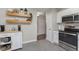 Kitchen with stainless steel appliances, floating shelves, and a functional kitchen cart at 8198 Wade Hill Ct, Indianapolis, IN 46256