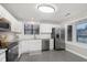 Updated kitchen featuring white cabinets, stainless steel appliances, and tile flooring at 8198 Wade Hill Ct, Indianapolis, IN 46256