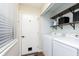 Well-equipped laundry room featuring a washer, dryer, and convenient shelving units at 8198 Wade Hill Ct, Indianapolis, IN 46256