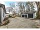Spacious backyard with patio, three-car garage, and mature trees at 8365 N Pennsylvania St, Indianapolis, IN 46240