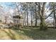 Large backyard with playset and mature trees at 8365 N Pennsylvania St, Indianapolis, IN 46240