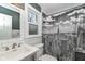 Updated bathroom with subway tile, a white sink, and a city-themed shower curtain at 8365 N Pennsylvania St, Indianapolis, IN 46240