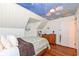 Upstairs bedroom with painted ceiling, wood floors, and built-in shelving at 8365 N Pennsylvania St, Indianapolis, IN 46240