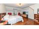 Bright bedroom with hardwood floors and built-in shelving at 8365 N Pennsylvania St, Indianapolis, IN 46240
