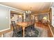 Spacious dining room with hardwood floors, a large table and access to adjacent rooms at 8365 N Pennsylvania St, Indianapolis, IN 46240