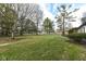 Landscaped front yard with mature trees and walkway at 8365 N Pennsylvania St, Indianapolis, IN 46240