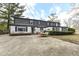 Two-story house with gray siding, white brick, and a backyard patio at 8365 N Pennsylvania St, Indianapolis, IN 46240