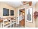 Small kitchen with breakfast bar and view into another room at 8365 N Pennsylvania St, Indianapolis, IN 46240