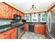 Updated kitchen with wood cabinets, granite countertops, and stainless steel appliances at 8365 N Pennsylvania St, Indianapolis, IN 46240