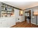 White built-in cabinetry and hardwood floors in this kitchen at 8365 N Pennsylvania St, Indianapolis, IN 46240