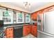 Updated kitchen with wood cabinets, granite countertops, and stainless steel appliances at 8365 N Pennsylvania St, Indianapolis, IN 46240