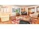 Bright living room featuring hardwood floors, fireplace, and ample seating at 8365 N Pennsylvania St, Indianapolis, IN 46240