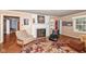 Living room with hardwood floors, fireplace, and large windows at 8365 N Pennsylvania St, Indianapolis, IN 46240