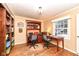 Home office with built-in shelving and a large desk with two chairs at 8365 N Pennsylvania St, Indianapolis, IN 46240