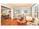 Bright sunroom with hardwood floors and comfortable seating at 8365 N Pennsylvania St, Indianapolis, IN 46240