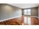 Spacious bedroom with hardwood floors and large window at 8650 Jaffa Ct W Dr # 12, Indianapolis, IN 46260