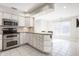 Eat-in kitchen with stainless steel appliances and white cabinets at 8650 Jaffa Ct W Dr # 12, Indianapolis, IN 46260
