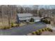 Aerial view of gray home with a long driveway and nice landscaping and small pond in the background at 8850 W State Road 46, Columbus, IN 47201