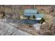 Aerial view of blue two-story home with a large driveway and landscaped yard at 8850 W State Road 46, Columbus, IN 47201