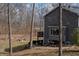 Backyard view of a grey home with a fire pit and seating area at 8850 W State Road 46, Columbus, IN 47201
