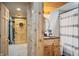Basement bathroom with wood vanity and shower/tub combo at 8850 W State Road 46, Columbus, IN 47201
