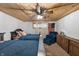 Basement bedroom with wood ceiling, twin beds, and American flag decor at 8850 W State Road 46, Columbus, IN 47201