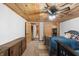 Cozy basement bedroom with wood ceiling and twin beds at 8850 W State Road 46, Columbus, IN 47201