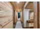 Long basement hallway with wood walls and carpet runner at 8850 W State Road 46, Columbus, IN 47201