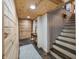 Basement hallway with wood walls and stairs at 8850 W State Road 46, Columbus, IN 47201