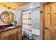 Modern bathroom with a soaking tub and wood vanity at 8850 W State Road 46, Columbus, IN 47201