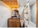 Basement bathroom with tub shower and wood vanity at 8850 W State Road 46, Columbus, IN 47201