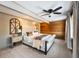 Main bedroom with plush bed, wood accent wall, and ample natural light at 8850 W State Road 46, Columbus, IN 47201
