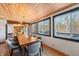 Bright dining room with large windows and a long wooden table at 8850 W State Road 46, Columbus, IN 47201