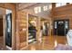 Sunlit entryway with wood features, staircase, and kitchen views at 8850 W State Road 46, Columbus, IN 47201