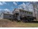 Two-story home features a deck, balcony, and stairway to the yard at 8850 W State Road 46, Columbus, IN 47201