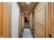 Long hallway with wood walls and tile flooring at 8850 W State Road 46, Columbus, IN 47201