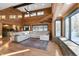 Spacious living room with large windows, hardwood floors, and a cozy sectional sofa at 8850 W State Road 46, Columbus, IN 47201