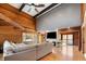 Open living area with hardwood floors, wood-paneled walls, and a modern fireplace at 8850 W State Road 46, Columbus, IN 47201