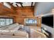 Spacious living room with vaulted ceilings, a large sectional sofa, and a fireplace at 8850 W State Road 46, Columbus, IN 47201