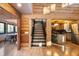 Open staircase with wood railings and kitchen views at 8850 W State Road 46, Columbus, IN 47201
