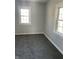 Simple bedroom with new gray carpeting and neutral walls at 1005 S Holmes Ave, Indianapolis, IN 46221