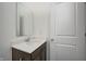 Clean bathroom with vanity, mirror, and dark brown cabinets at 1011 Grassy Branch Dr, Indianapolis, IN 46239