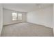 Simple bedroom with grey carpet and two large windows at 1011 Grassy Branch Dr, Indianapolis, IN 46239