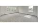 Well-lit bedroom featuring grey carpet and triple windows at 1011 Grassy Branch Dr, Indianapolis, IN 46239