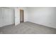 Bright bedroom featuring grey carpet and double doors leading to a hallway at 1011 Grassy Branch Dr, Indianapolis, IN 46239