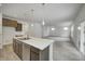 Open concept kitchen island with stainless steel appliances and hardwood floors at 1011 Grassy Branch Dr, Indianapolis, IN 46239