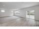 Spacious living room with hardwood and carpeted floors, and sliding glass doors at 1011 Grassy Branch Dr, Indianapolis, IN 46239